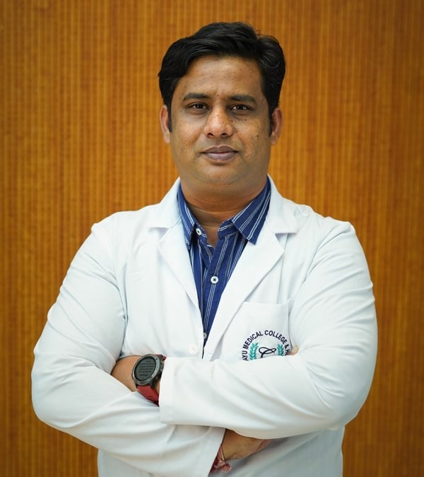 Dr. Manish Borasi, wearing a white coat, standing confidently with arms crossed, representing professionalism and expertise in his field.