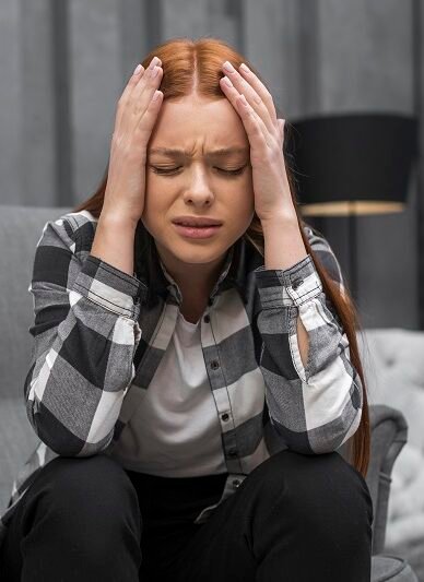Stressed woman holding her head in pain showing anxiety and mental distress requiring Anxiety Treatment in Bhopal
