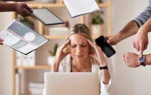 Woman feeling overwhelmed by work pressure and multitasking, showing symptoms of anxiety and stress related to anxiety treatment in Bhopal.